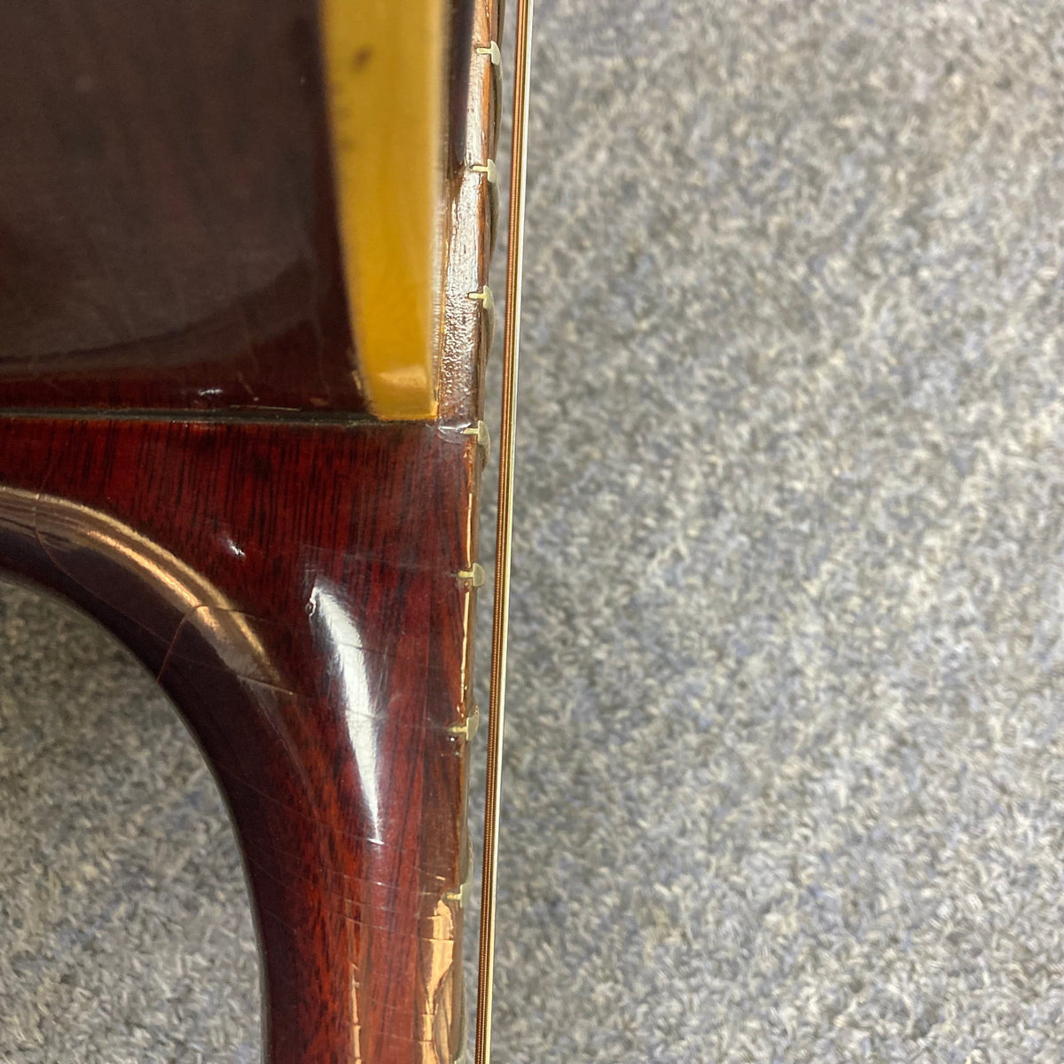 Close-up of a 1968 Gibson B25 Acoustic Guitar showcasing its vintage checking and fine craftsmanship.