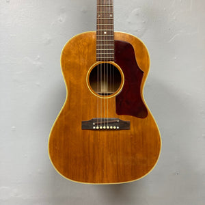 Gibson B-25 Acoustic Guitar Natural 1968, displayed on a wall, showcasing vintage checking and crafted in Kalamazoo.