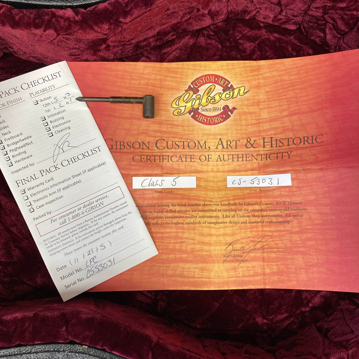 Gibson Custom Shop Class 5 Les Paul certificate of authenticity and checklist, in a red case with metal tool—ideal for your prized Gibson Les Paul.
