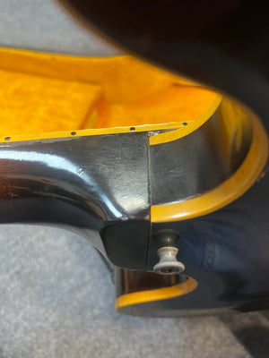 Close-up of a vintage Gibson ES-335TD-12 1968 Sunburst shows a seam or crack repair near the edge, visible screw, and varnished wood interior.
