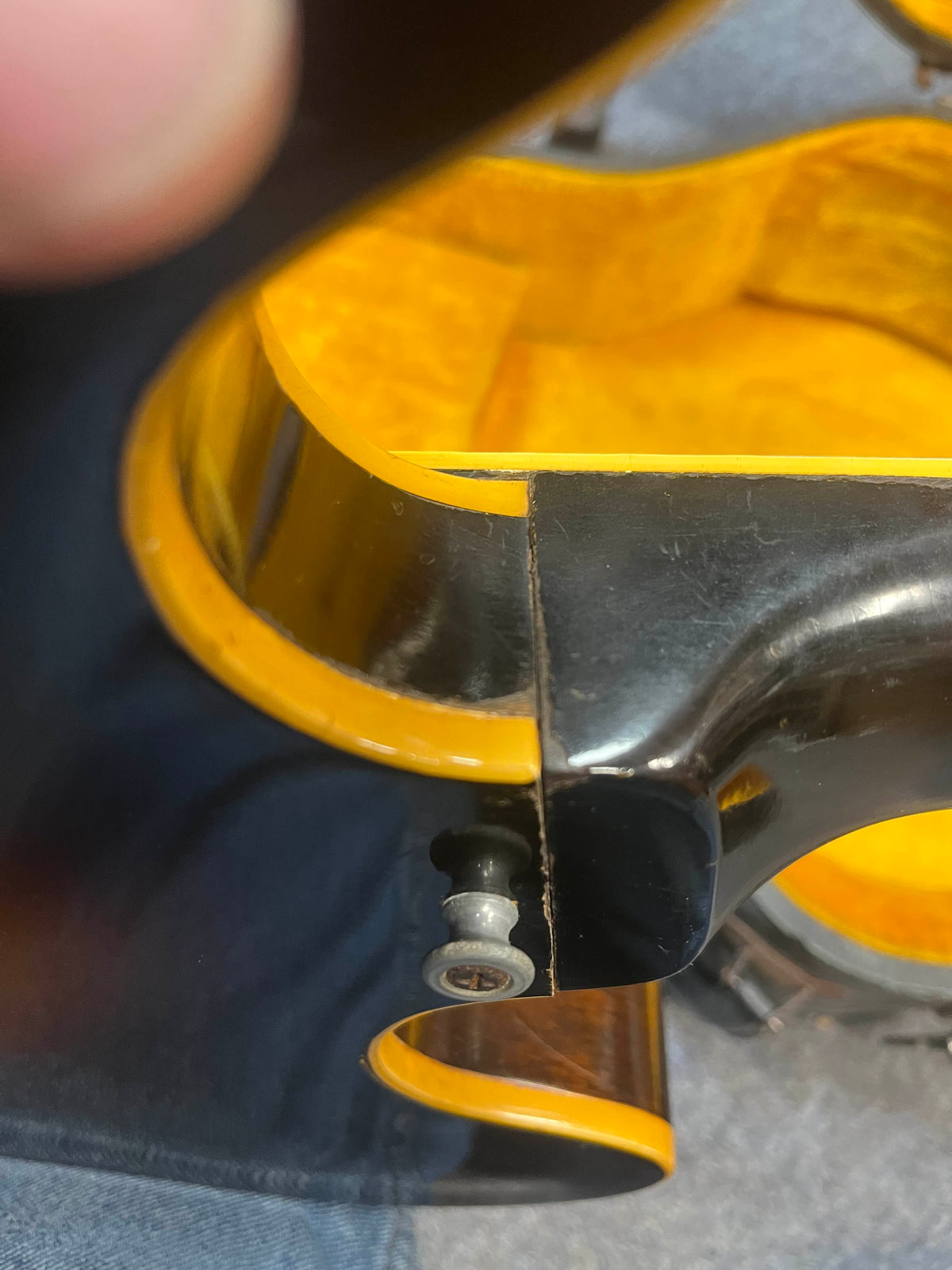 Close-up of a Gibson ES-335TD-12 1968 Sunburst neck joint, showing a visible crack or seam separation and a metal fitting attached to the bottom edge. Includes case.