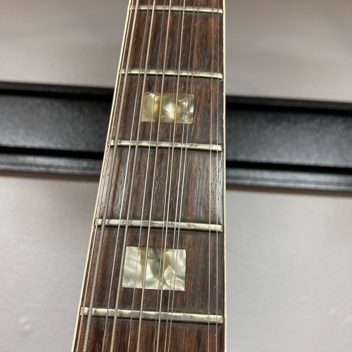 Close-up of a Gibson ES-335TD-12 guitar neck and strings, highlighting the craftsmanship and iconic design.