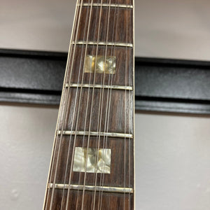 Close-up of a Gibson ES-335TD-12 guitar neck and strings, highlighting the craftsmanship and iconic design.