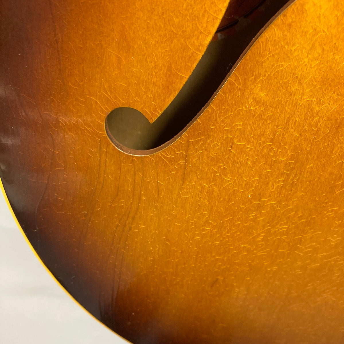Close-up of the 1968 Gibson ES-335TD-12 12-string guitar showcasing its sunburst finish and double-cutaway design.