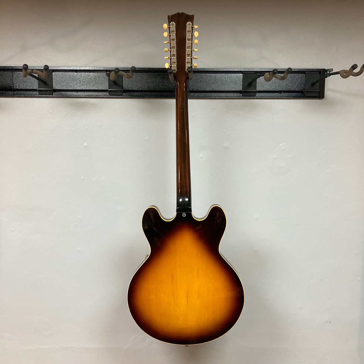 Gibson ES-335TD-12 1968 Sunburst guitar, semi-hollow body with 12 strings, displayed on a wall.
