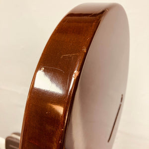 Close-up of the side of a Gibson Les Paul Junior 1957 Sunburst by Gibson, featuring a visible scratch and dent on the polished wooden surface.