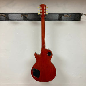 Gibson Les Paul Standard Premium Plus 2003 Ice Tea Burst guitar displayed on a rack. Features flamed maple top and Burstbucker Pro pickups.