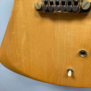 Close-up of a Gibson RD Artist 1977-1982 electric guitar body from Guitars on Main, highlighting the bridge, input jack, and toggle switch on a light wood finish—an iconic collectible with case included.