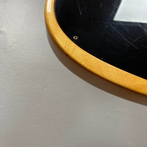 Close-up of a Gibson RD Artist 1977-1982 w/Case by Guitars on Main, highlighting its glossy black finish with visible scratches and a metallic screw, set against a plain light-colored background.