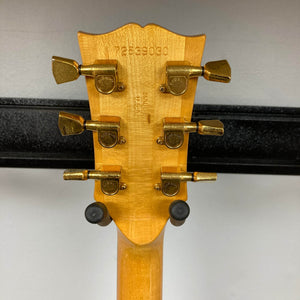 Close-up of the back of a Gibson RD Artist 1977-1982 headstock from Guitars on Main, featuring six gold tuners and a stamped serial number—a true collectible for vintage electric guitar lovers. Includes case.