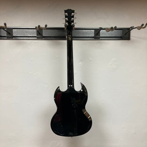 Gibson SG Modern Exclusive Dark Purple Burst Blem displayed on a wall, showcasing its sleek design and premium features, perfect for all guitar enthusiasts.