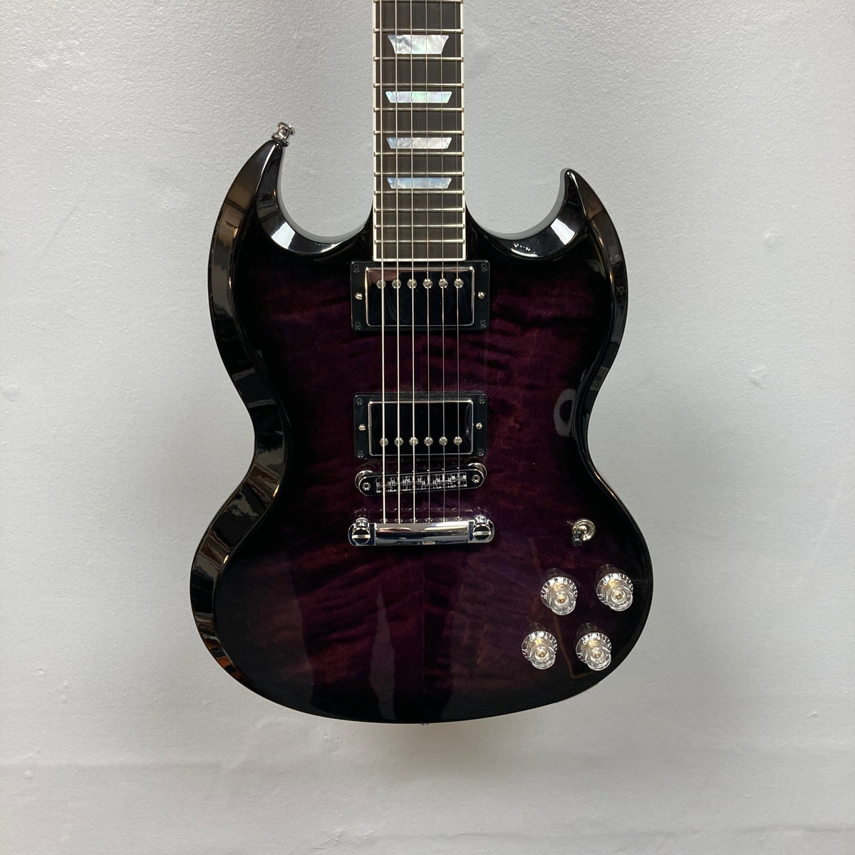 Close-up of the Gibson SG Modern Exclusive Dark Purple Burst Blem guitar, highlighting its strings and sleek design.