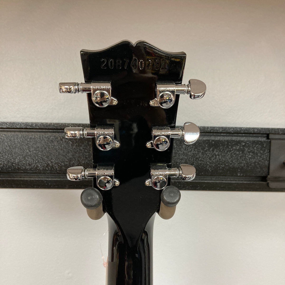 Close-up of a Gibson SG Modern Exclusive Dark Purple Burst Blem guitar, showcasing its sleek, modern design and high-quality craftsmanship.