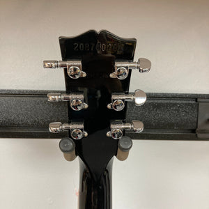 Close-up of a Gibson SG Modern Exclusive Dark Purple Burst Blem guitar, showcasing its sleek, modern design and high-quality craftsmanship.