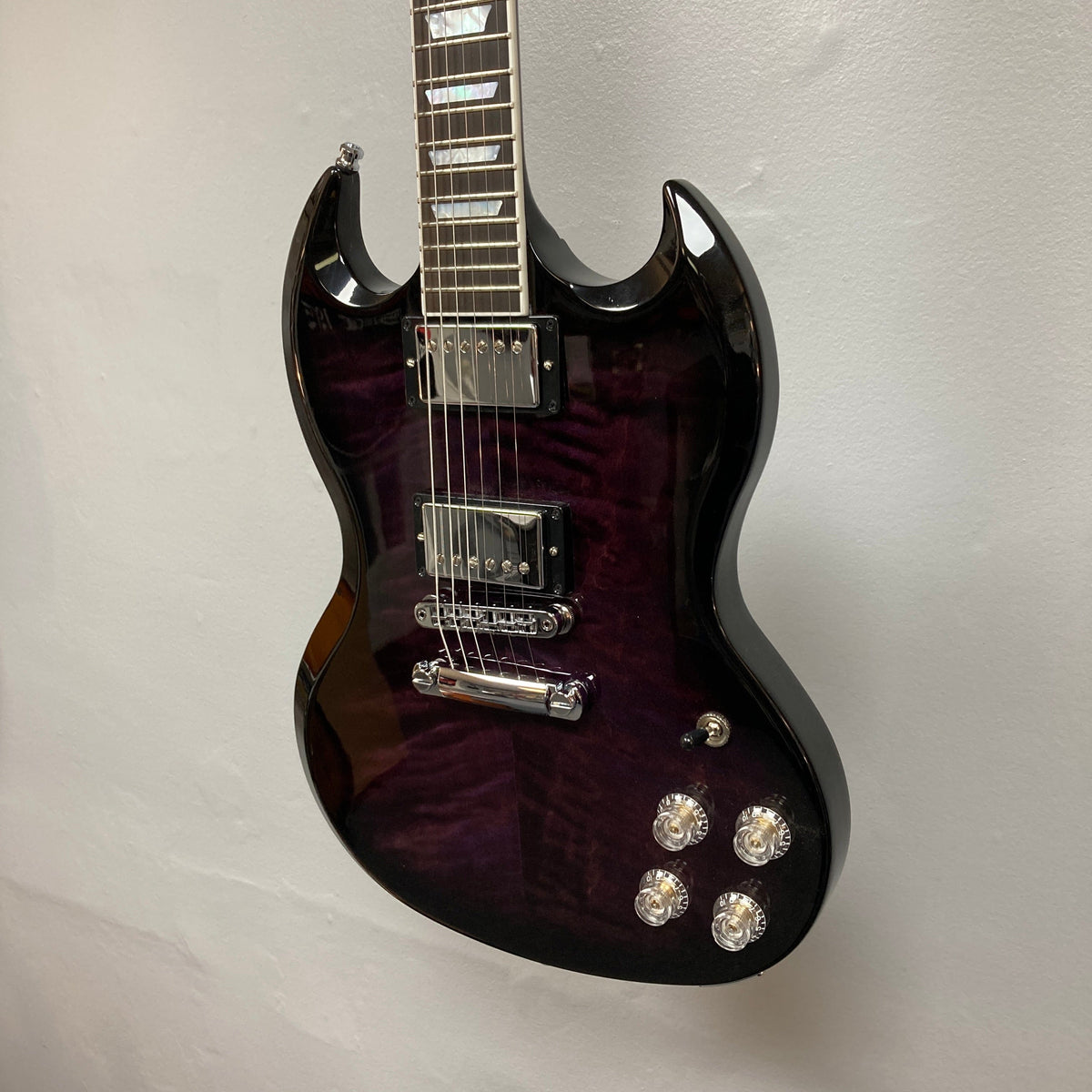 Gibson SG Modern Exclusive Dark Purple Burst Blem, a sleek electric guitar with modern design and premium features, ideal for experienced players and beginners.