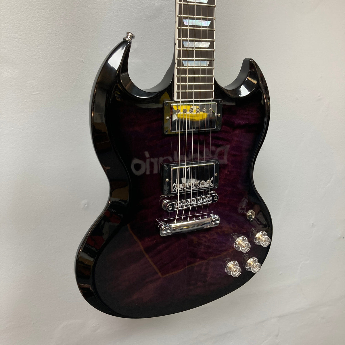 Gibson SG Modern Exclusive Dark Purple Burst Blem electric guitar, featuring a sleek design and premium build, displayed on a wall.