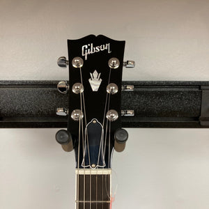 Gibson SG Modern Exclusive Dark Purple Burst Blem guitar headstock on a stand, showcasing sleek design and premium features for all players.