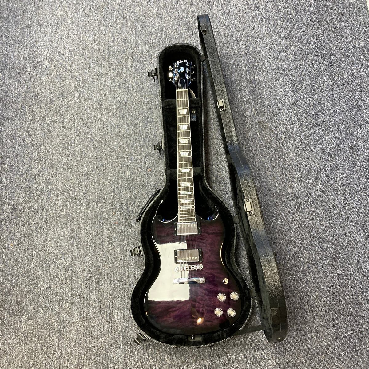 Gibson SG Modern Exclusive Dark Purple Burst Blem in a case, showcasing a sleek design and premium features for players.
