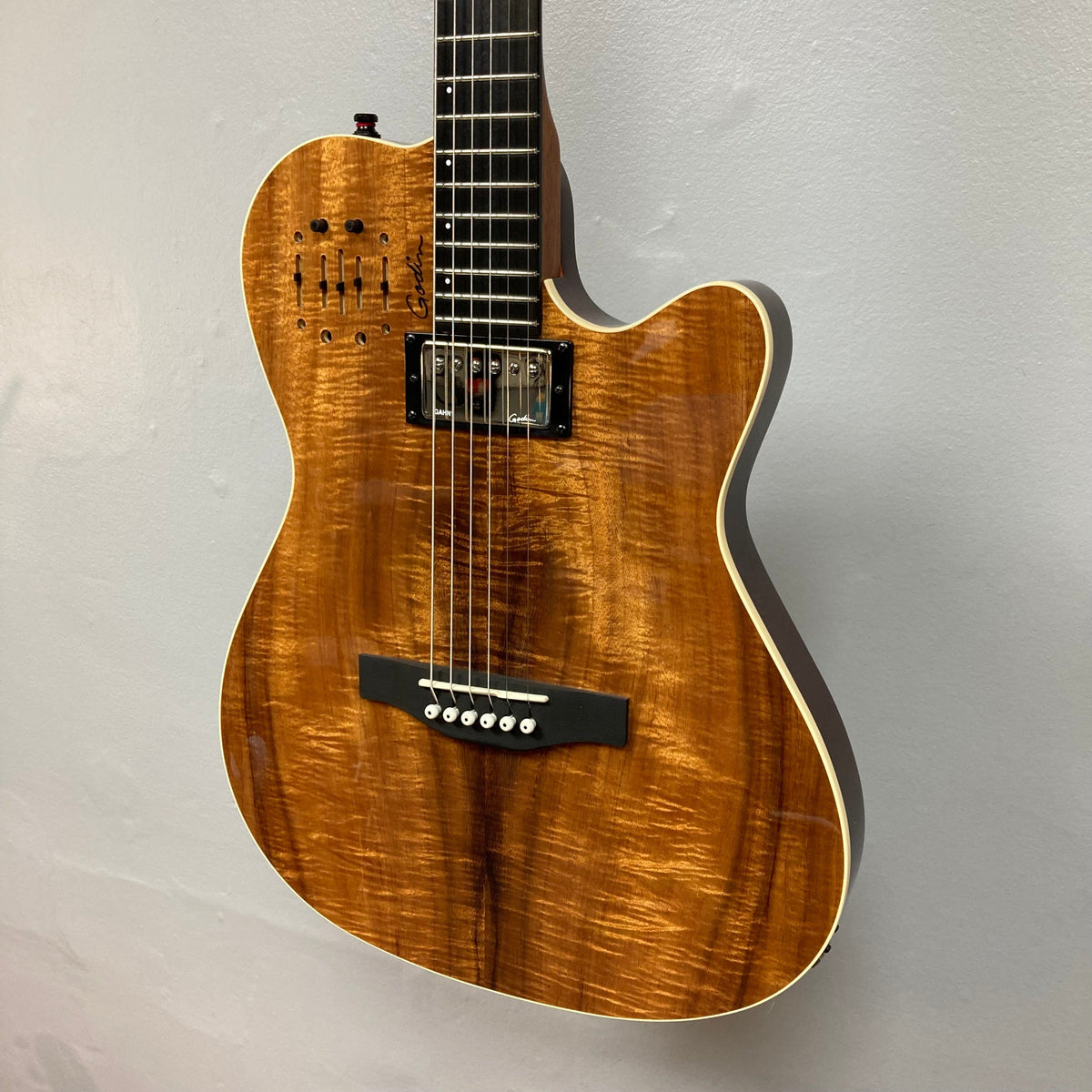 Godin A6 Ultra Koa Extreme SF guitar, close-up showing strings and neck, highlighting its dual outputs and innovative preamp features.