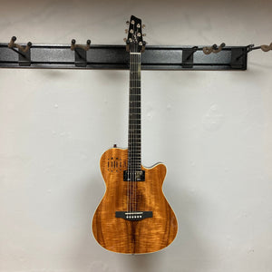 Godin A6 Ultra Koa Extreme SF electric guitar displayed on a wall, showcasing its neck and body design, available with a gig bag.