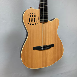 Godin Ltd Multiac ACS Cedar Matte SG w/GigBag displayed on a wall, showcasing its cedar top and comfortable neck design.