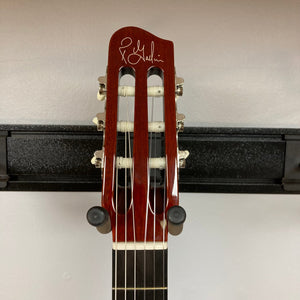 Godin Ltd Multiac ACS Cedar Matte SG w/GigBag features a close-up of the guitar head and neck on a stand, showcasing its solid body design.