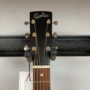 Godin Mahogany Folk Rustic Burst A/E guitar on a stand with visible strings and knobs.