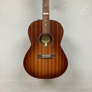 Godin Mahogany Folk Rustic Burst A/E acoustic guitar, showcasing its solid mahogany body and strings, mounted on a wall.