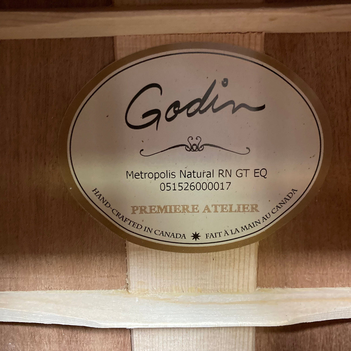 Close-up of Godin Metropolis Natural RN GT EQ label on an acoustic guitar, highlighting its detailed design and superior craftsmanship.
