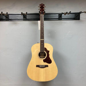Godin Metropolis Natural RN GT EQ on wall, highlighting its solid spruce top, mahogany back and sides, and rosewood fretboard.