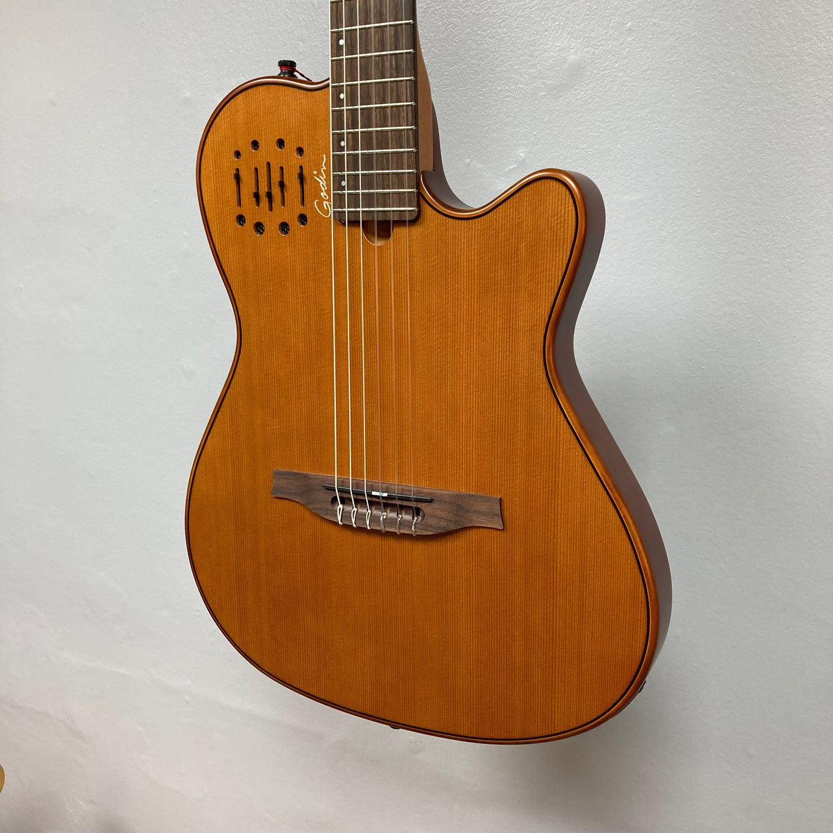 Godin Prototype Ltd Mundial Dark Cedar w/GigBag, nylon-string guitar with visible strings, crafted with Silver Leaf Maple body and Cedar top.