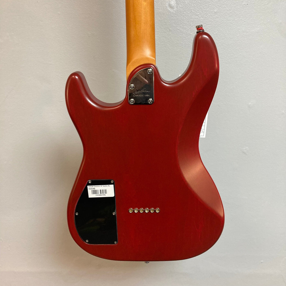 Red Godin Session HT electric guitar with fixed bridge and HSS pickups, featuring a maple fingerboard and semi-gloss finish.