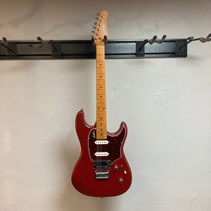 Godin Session HT MN Aztek Red guitar with fixed bridge, HSS pickups, and maple fingerboard displayed on a wall.