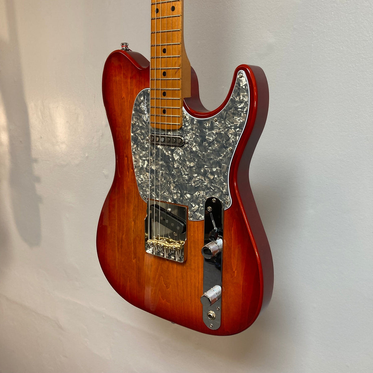 Godin Stadium Pro Sunset Burst MN w/GigBag Electric Guitar close-up, showcasing its Laurentian Basswood body and Rock Maple neck, highlighting premium pickups and adjustable bridge.