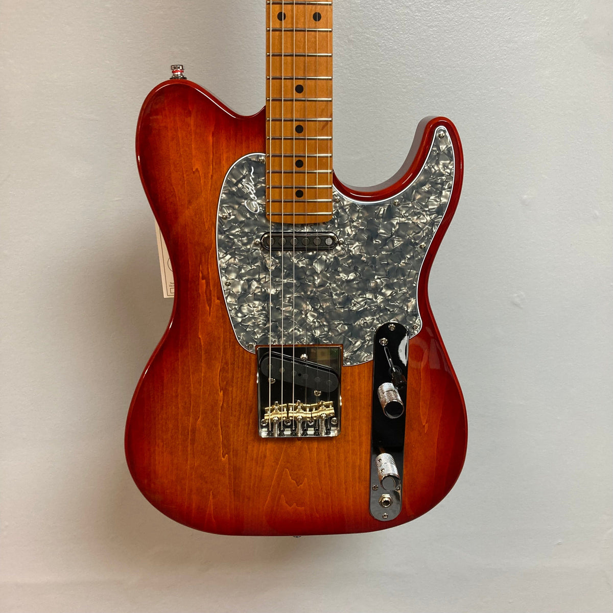 Close-up of the Godin Stadium Pro Sunset Burst MN Electric Guitar, showcasing the detailed bridge, knobs, and strings.