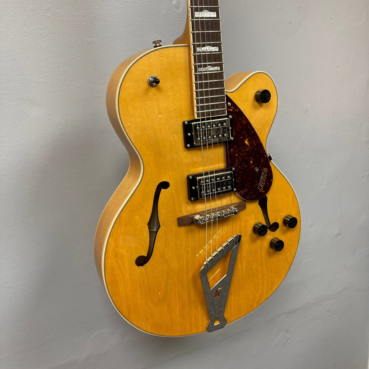 Gretsch G2420 Village Amber Used guitar on display, highlighting its hollowbody design and classic Gretsch features like Broad'Tron humbuckers and F-holes.