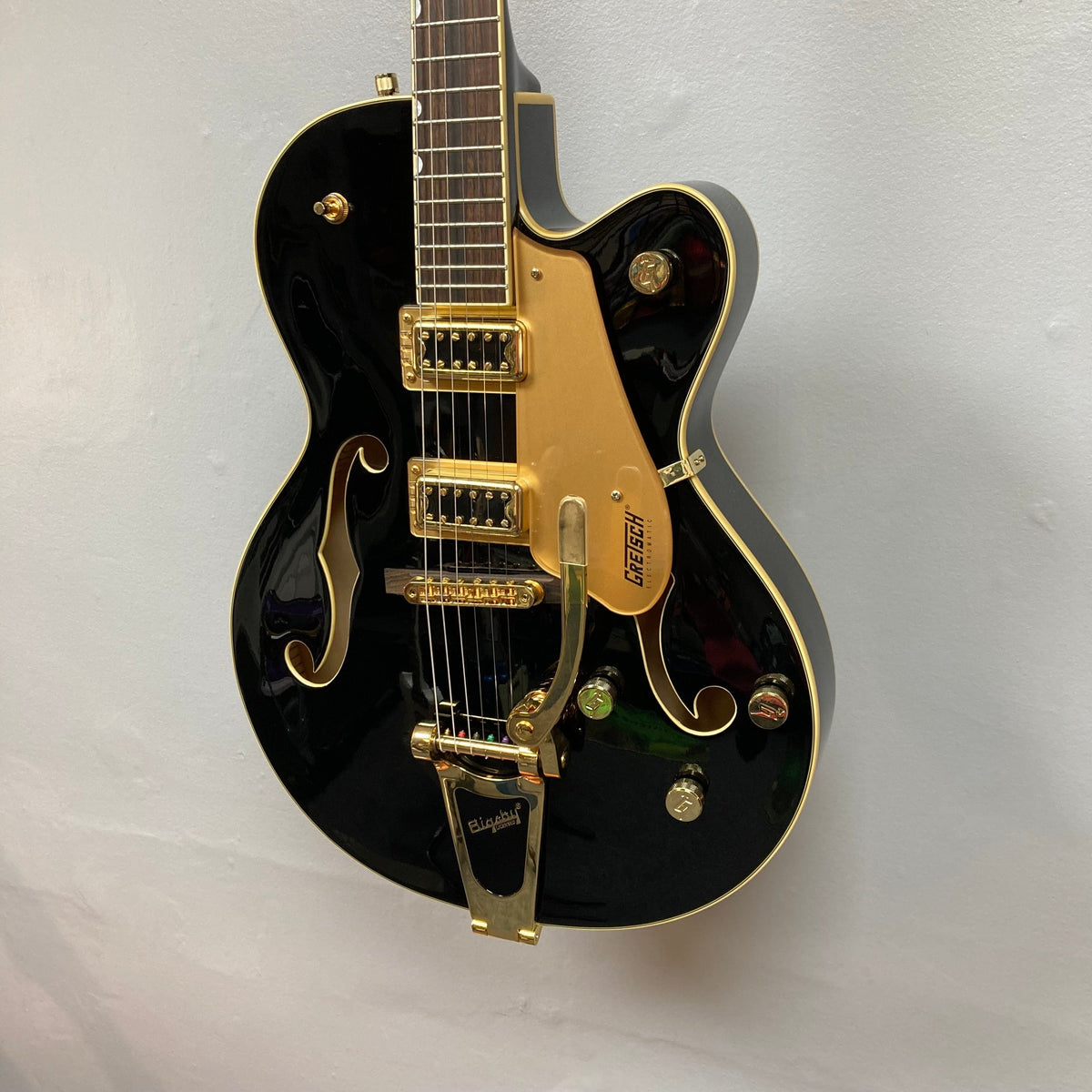 Gretsch G5420TG Electromatic Black Gold guitar with Filter'Tron pickups and Bigsby Vibrato tailpiece, showcasing a vintage-inspired design and modern playability.