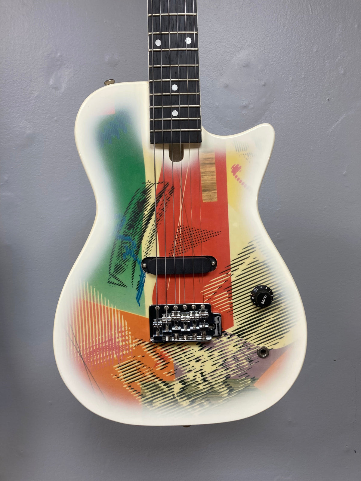 Gretsch Traveling Wilburys TW-100T Electric Guitar displayed on a wall, showcasing its unique design and excellent condition.