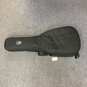 Guild Jumbo Junior Bass guitar case on carpet, showcasing the sturdy protective bag included, highlighting its appeal for musicians from 'Guitars on Main'.