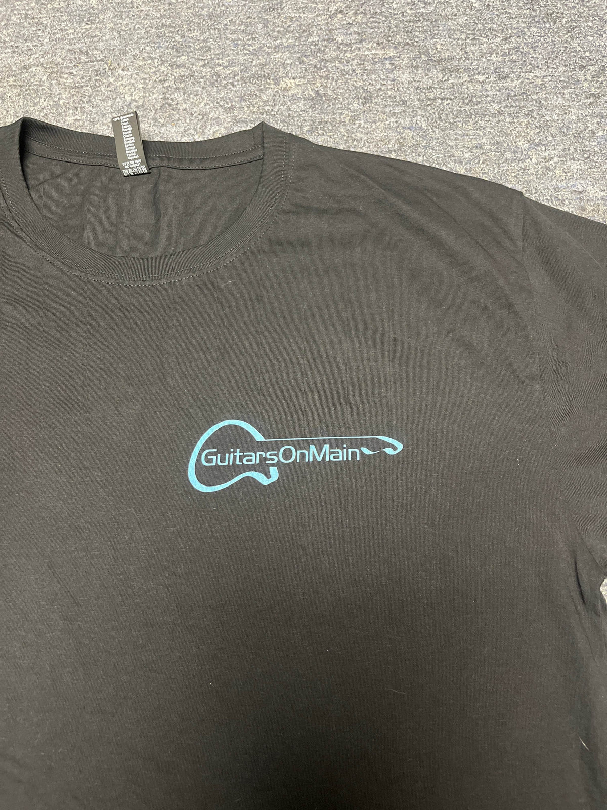 Close-up of Guitars on Main logo on black t-shirt