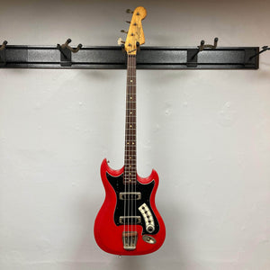 Hagstrom HII-B Mid-1960s red bass guitar, four-string, displayed on a wall rack, featuring original pickups and distinct Scandinavian design, from 'Guitars on Main'.