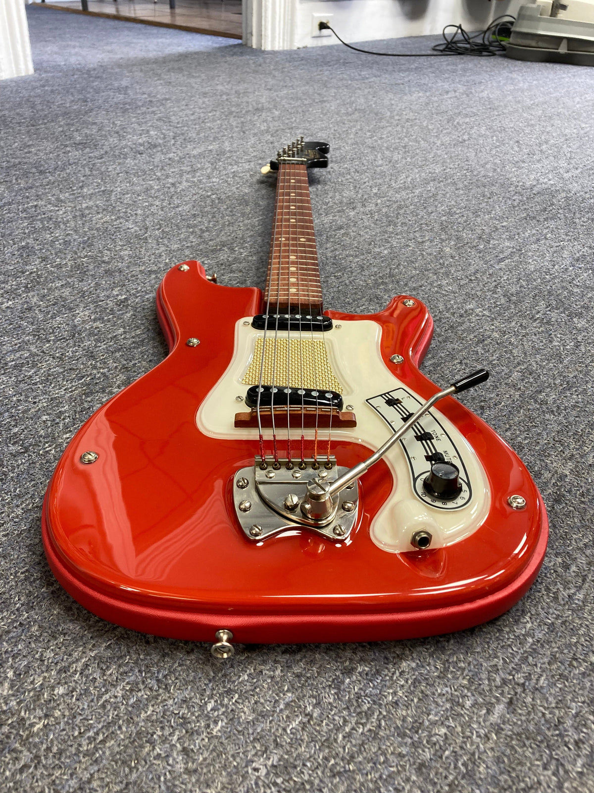 Hagstrom I Vintage Electric Guitar with original flatwound strings, featuring a red and white body, Brazilian Rosewood fretboard, and a slender neck for enhanced playability.