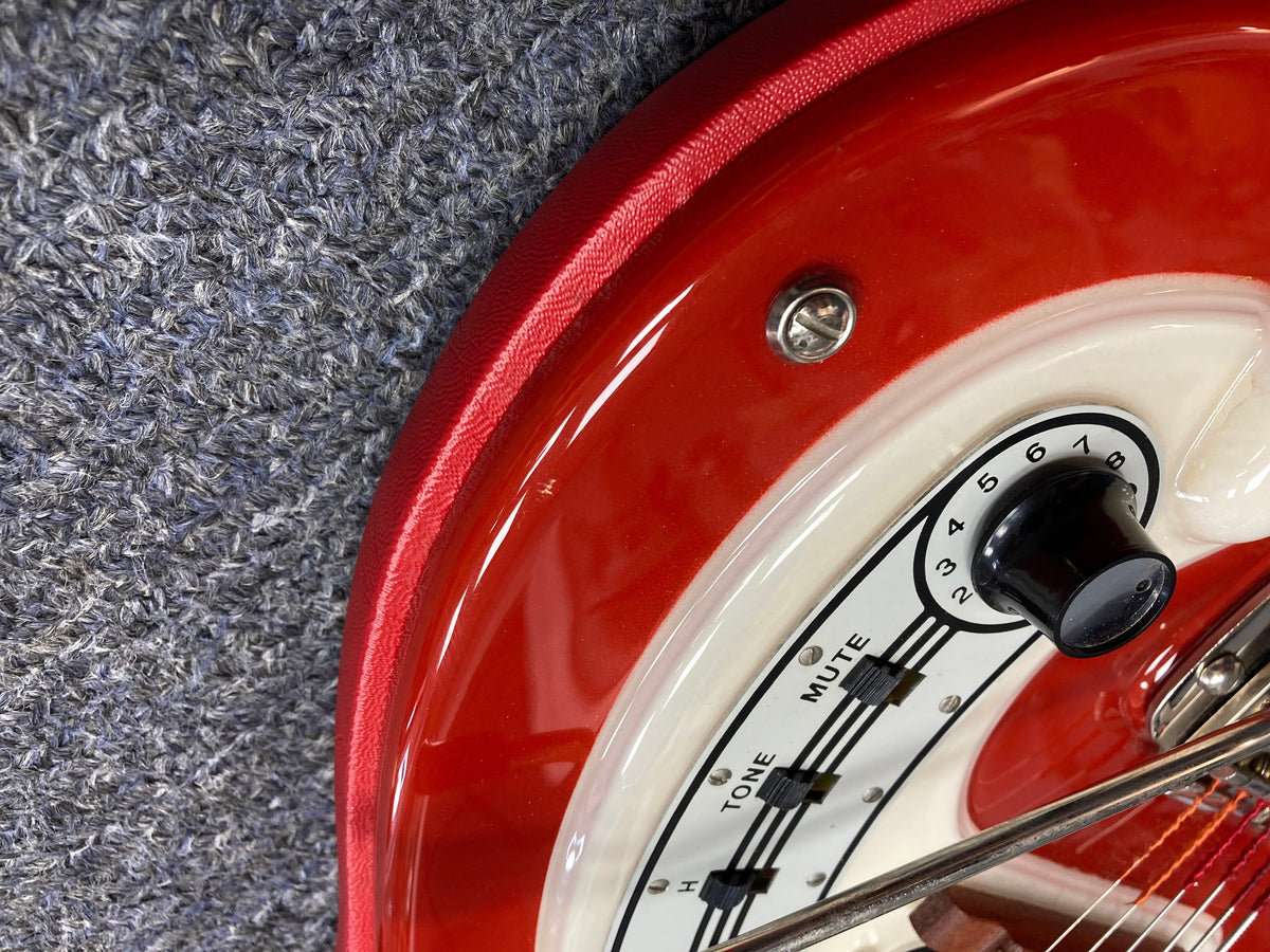 Close-up of a Hagstrom I Vintage Electric Guitar, showcasing its red and white body, original flatwound strings, and pristine condition.
