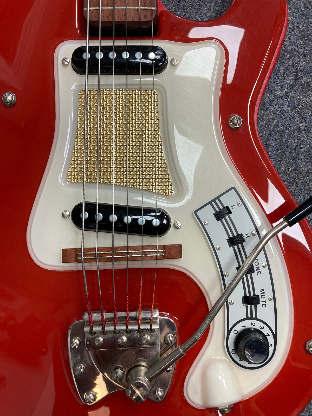 Hagstrom I Vintage Electric Guitar, close-up of red and white body, strings, and dials, showcasing pristine condition and original flatwound strings.