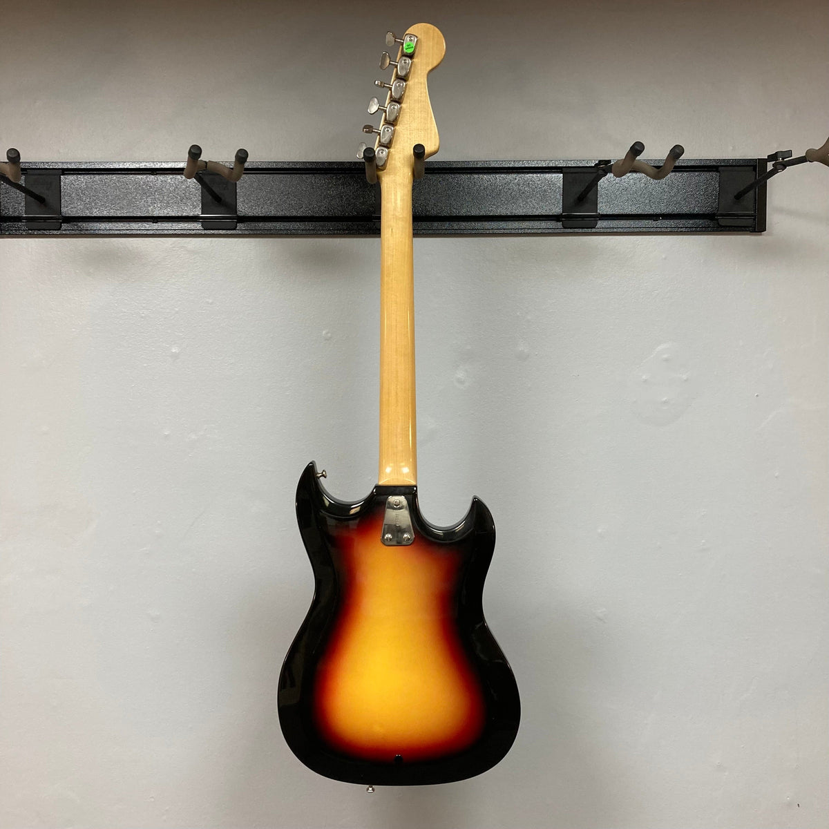 Hagstrom III Left Hand 1960s Sunburst Electric Guitar on a stand, showcasing its classic vintage-inspired design and three single-coil pickups.