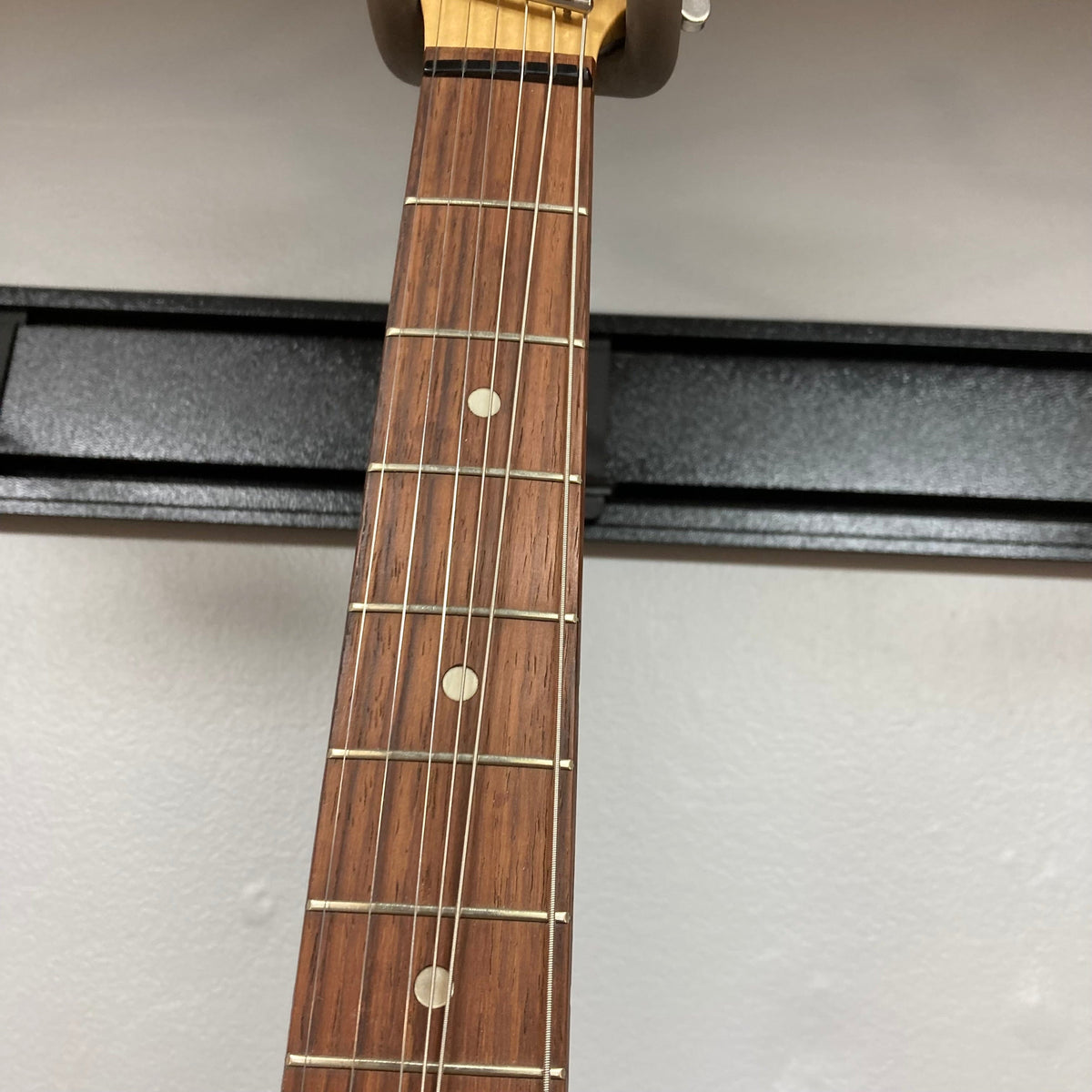 Hagstrom III Left Hand 1960s Sunburst Electric Guitar w/Case on display, showcasing its vintage-inspired neck and sunburst finish.