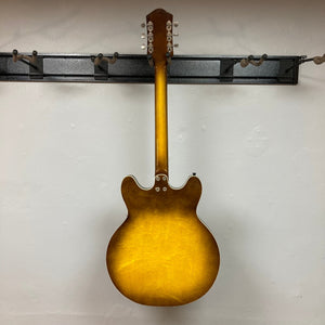 Harmony H-75 1960s Sunburst electric guitar on display, showcasing its elegant design and sunburst finish.