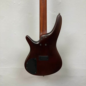 Back view of an Ibanez SDGR SR500PB w/Hard case bass guitar in dark brown, showing its smooth finish, visible neck, control cavity cover, and mounting screws against a plain light background.