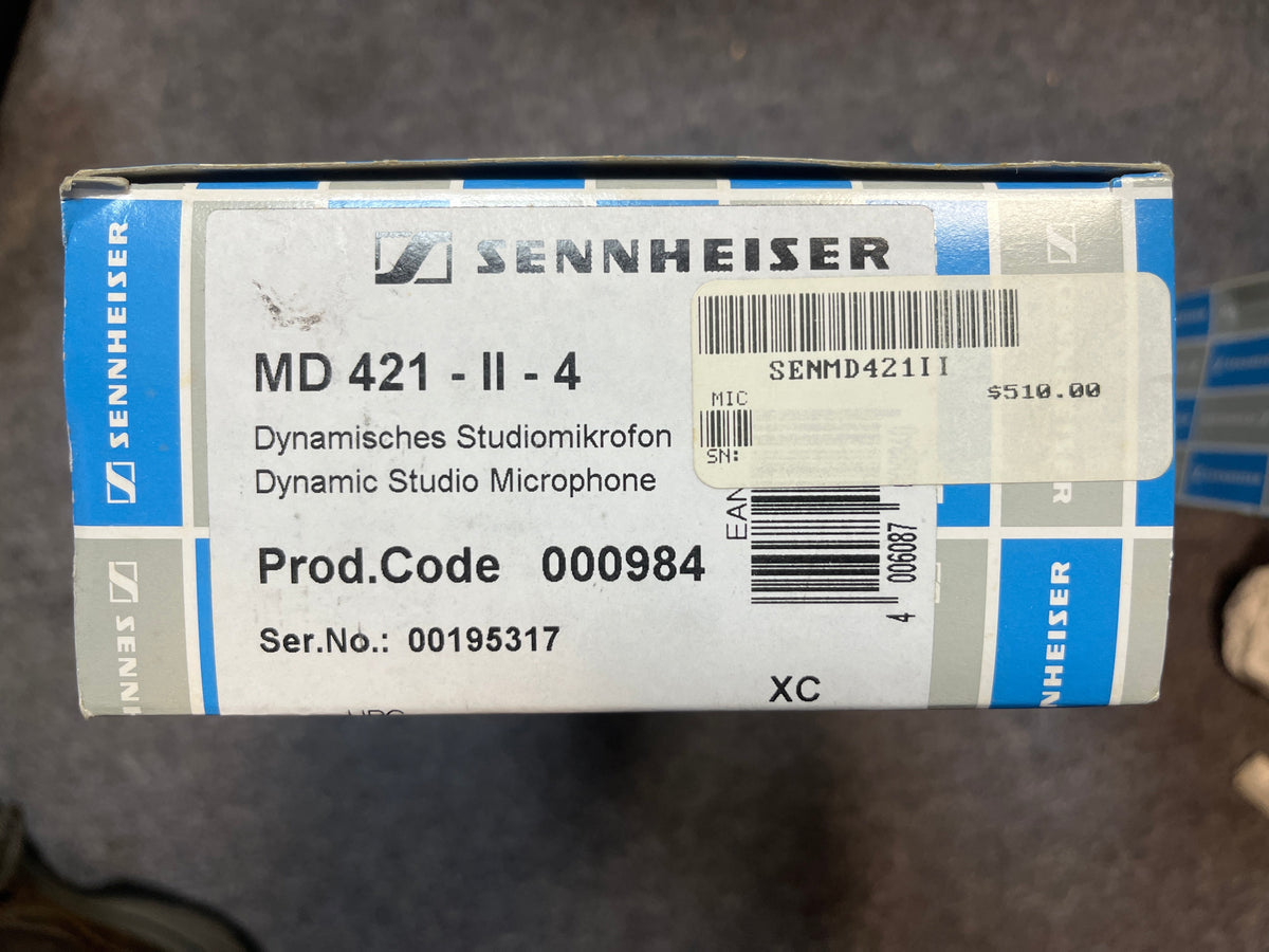 A Sennheiser MD 421-II Dynamic Studio Microphone (Preowned) box with product and serial numbers, barcode, and a $510.00 price tag.