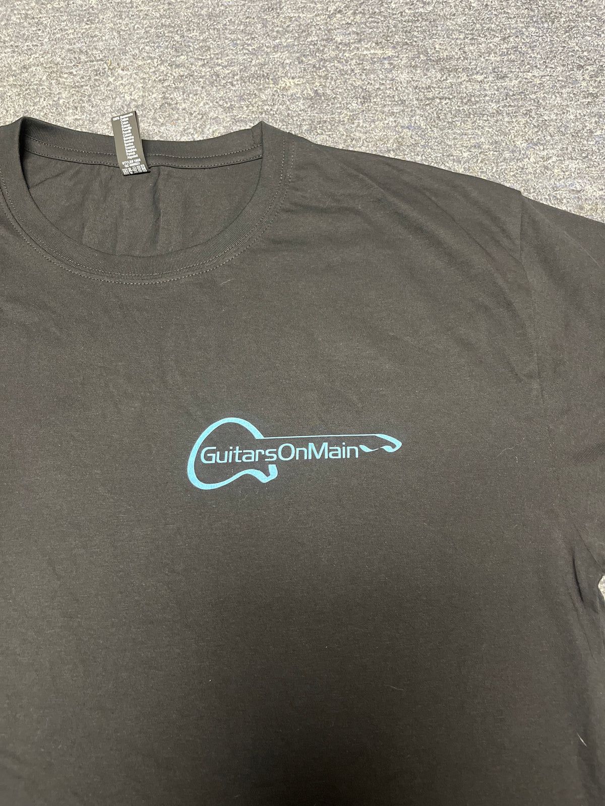 Close-up of Guitars on Main logo on black t-shirt